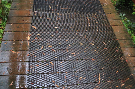 Metal mesh across wooden bridge